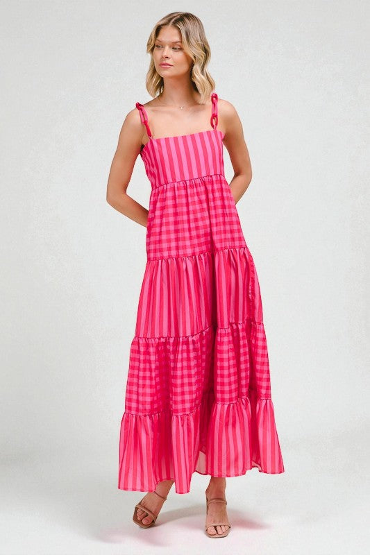 Woman wearing a pink checkered dress on a white background