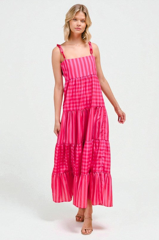 Woman wearing a pink and white striped dress on a white background