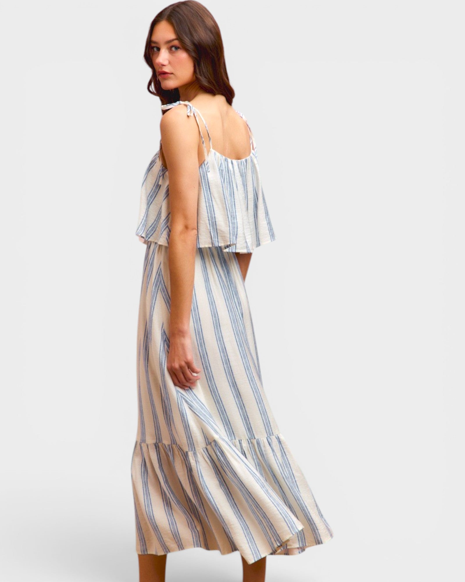 Woman wearing a striped dress on a plain background