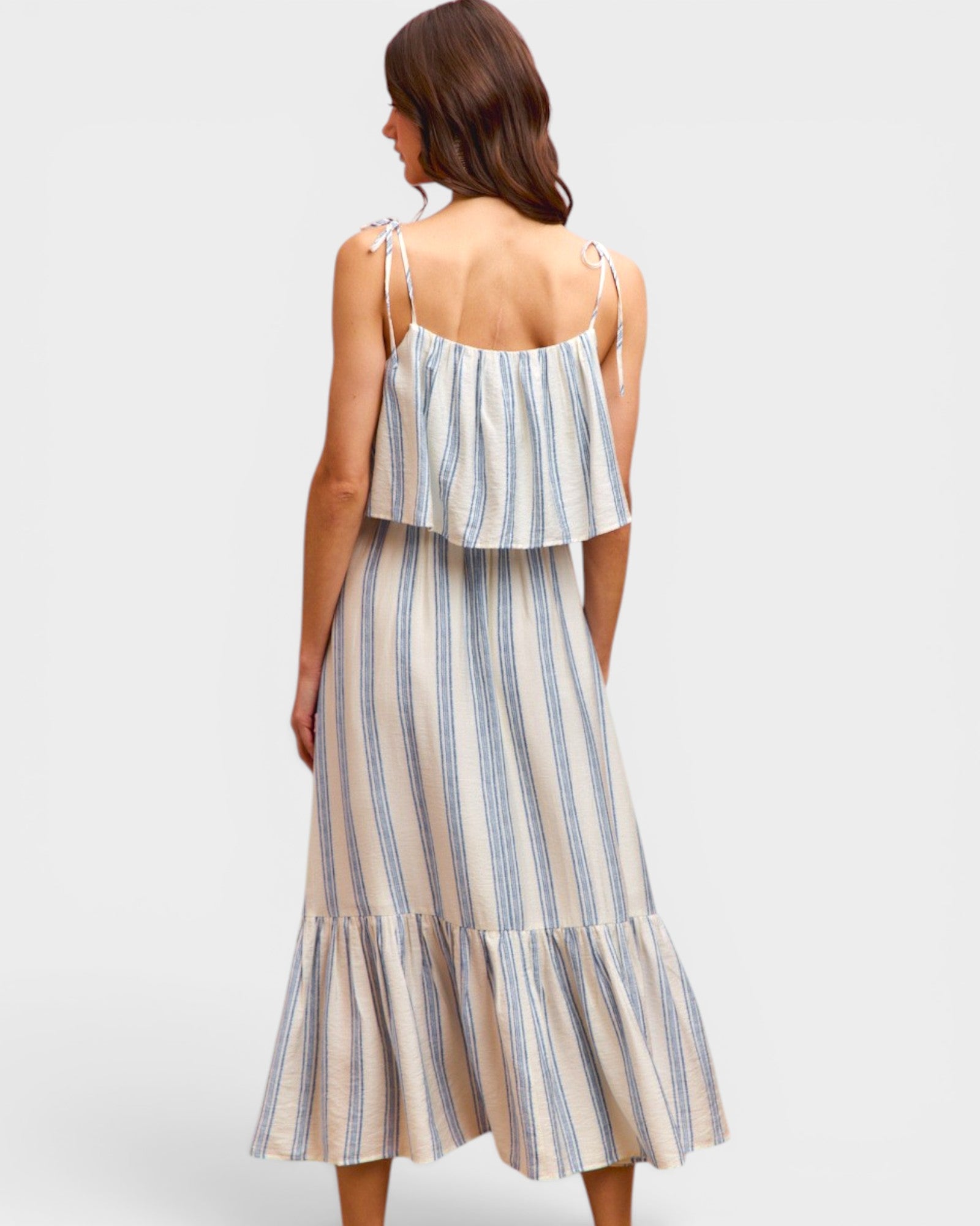 Woman wearing a striped dress with a plain background