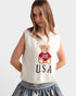 Woman wearing a sleeveless top with a teddy bear and 'USA' text design on a plain background