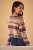 Woman wearing a striped sweater against a beige background