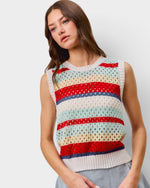 Woman wearing a colorful striped sleeveless sweater against a plain background