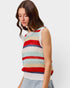 Woman wearing a colorful striped sleeveless sweater against a plain background