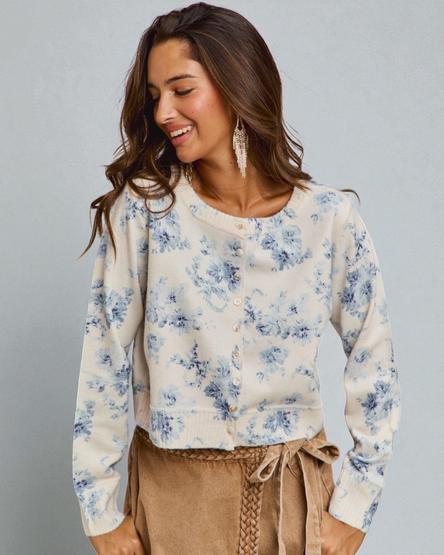 Woman wearing a floral blouse with a gray background