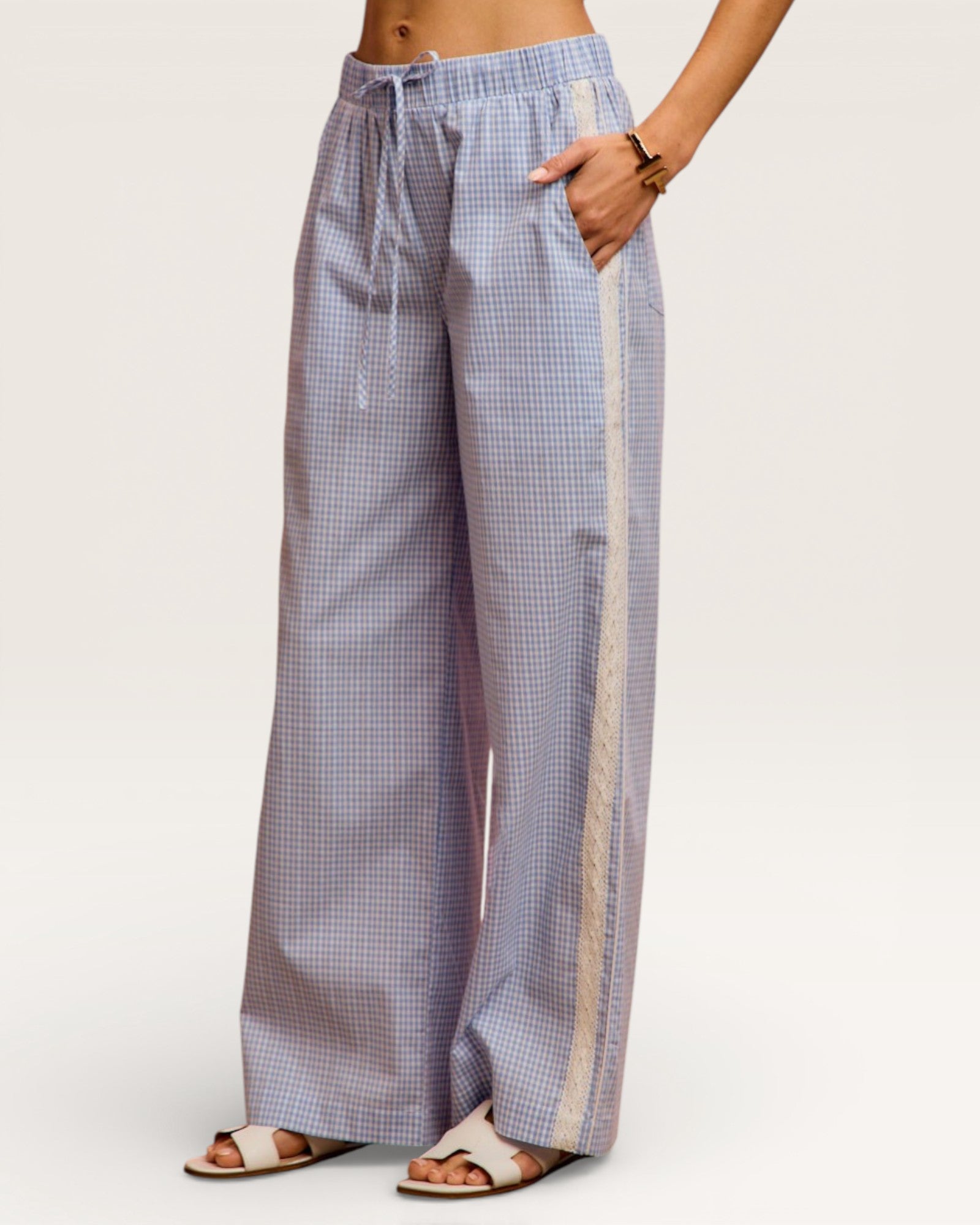 Checkered wide-leg pants worn by a person on a white background