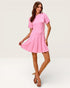 Woman wearing a pink dress on a white background