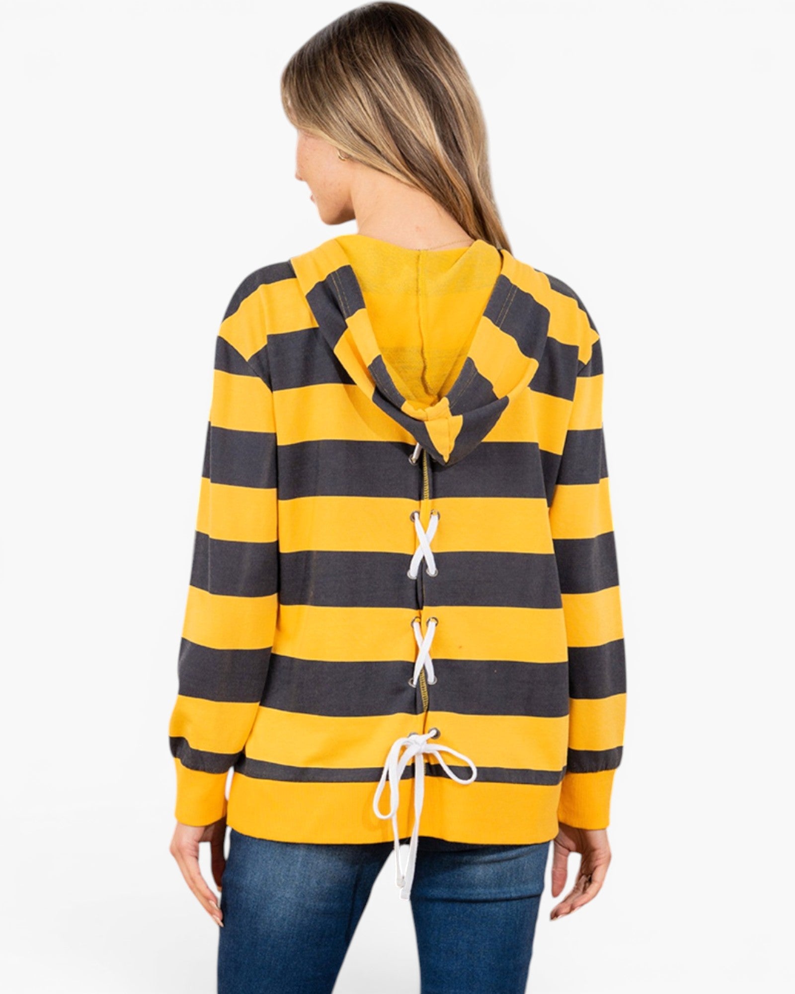 A woman shown from the back wearing a yellow and dark gray striped hooded sweatshirt with white laces down the center, paired with blue jeans, against a plain white background.