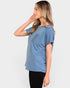 Woman wearing a blue t-shirt against a white background