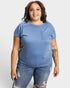 Woman wearing a blue t-shirt and jeans on a white background