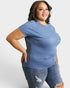 Woman wearing a blue t-shirt and jeans on a white background