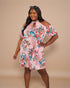 Woman wearing a floral dress against a beige background