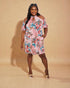 Woman wearing a floral dress against a beige background