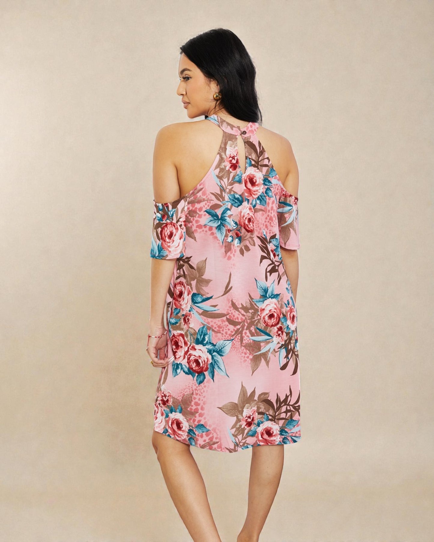 Woman wearing a floral dress on a beige background