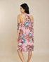 Woman wearing a floral dress on a beige background