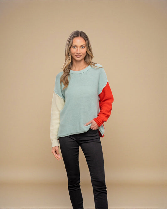 Woman wearing a multicolored sweater with a beige background