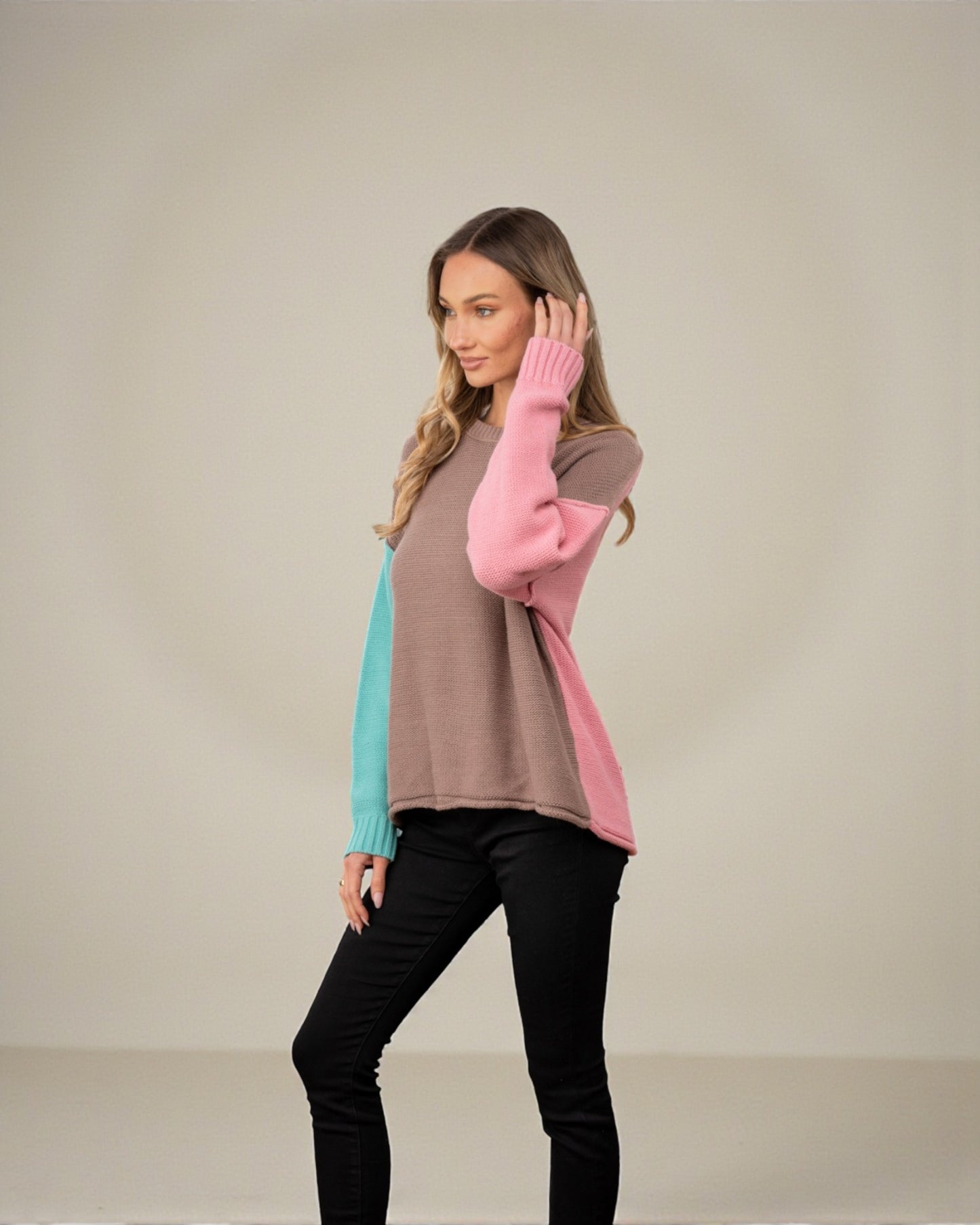 Woman wearing a colorful sweater with a neutral background