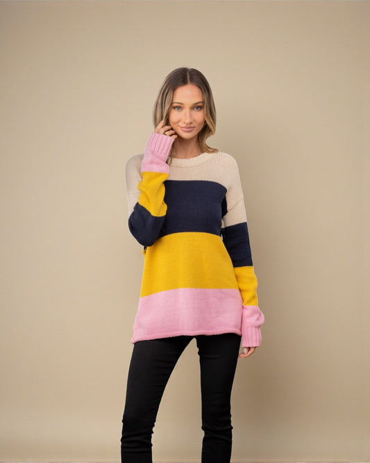 Woman wearing a colorful sweater with a beige background