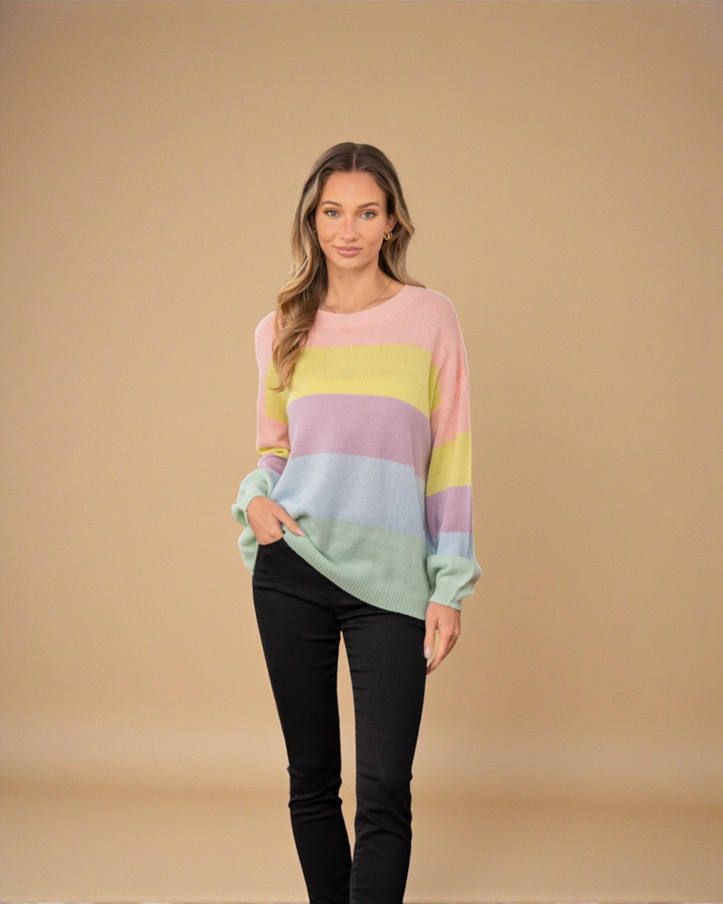 Woman wearing a pastel striped sweater against a beige background