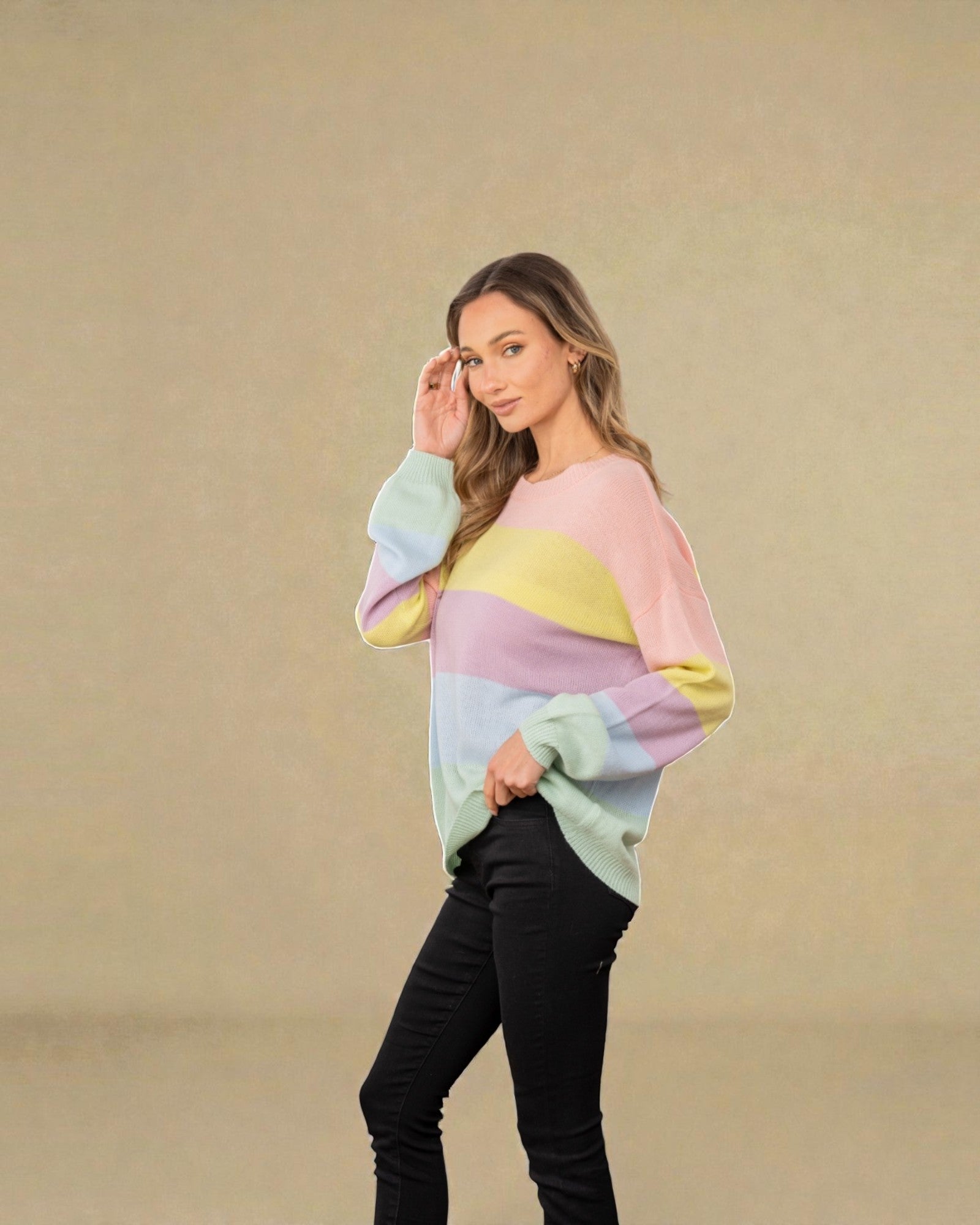 Woman wearing a colorful sweater against a beige background