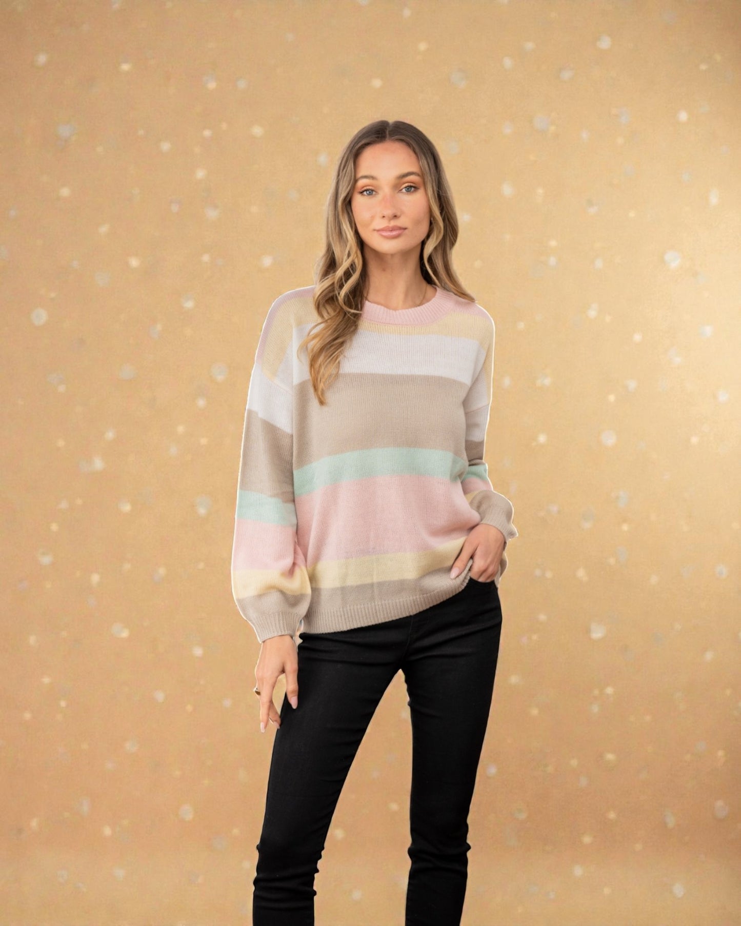 Woman wearing a colorful striped sweater against a beige background