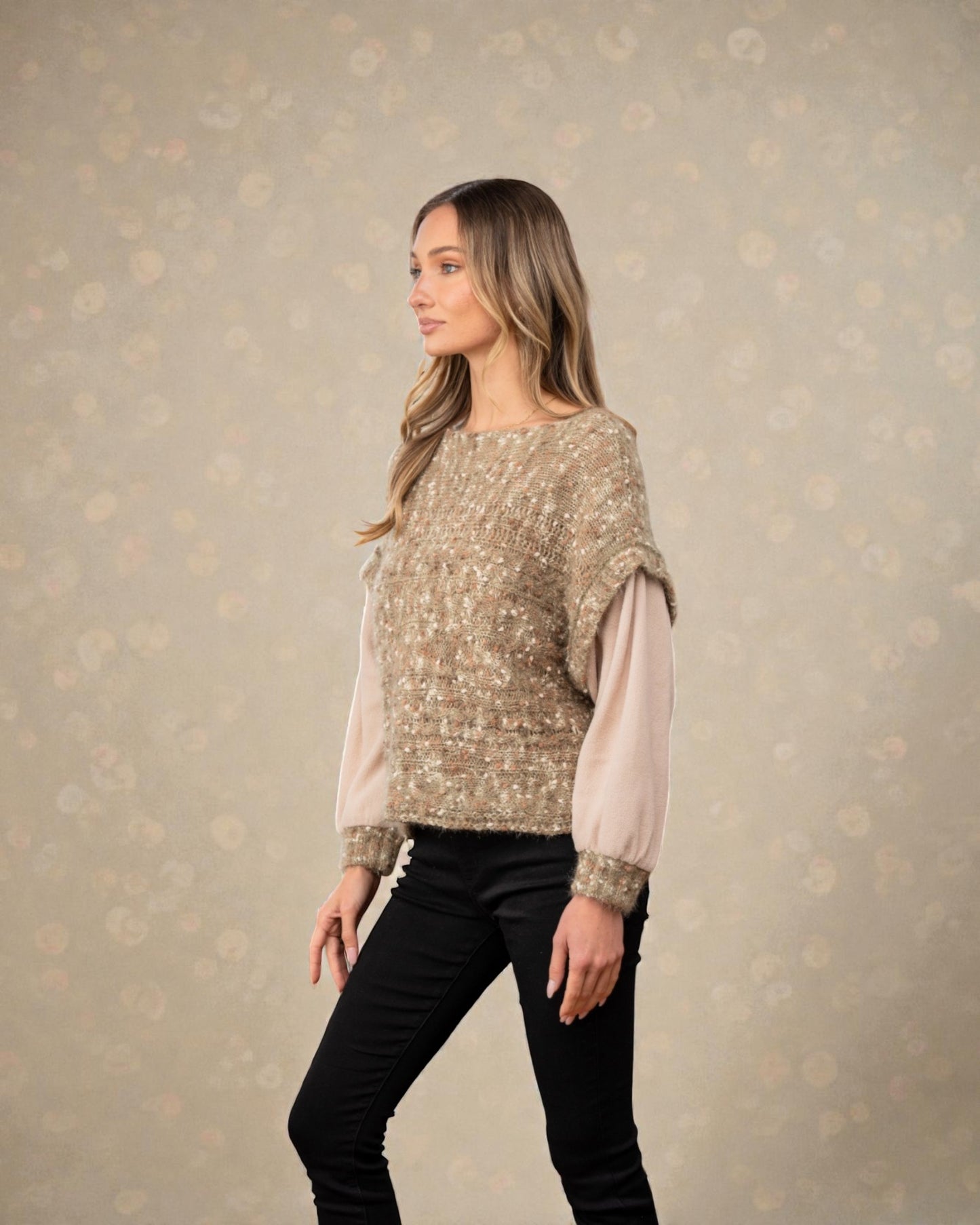 Woman wearing a patterned top with a plain background