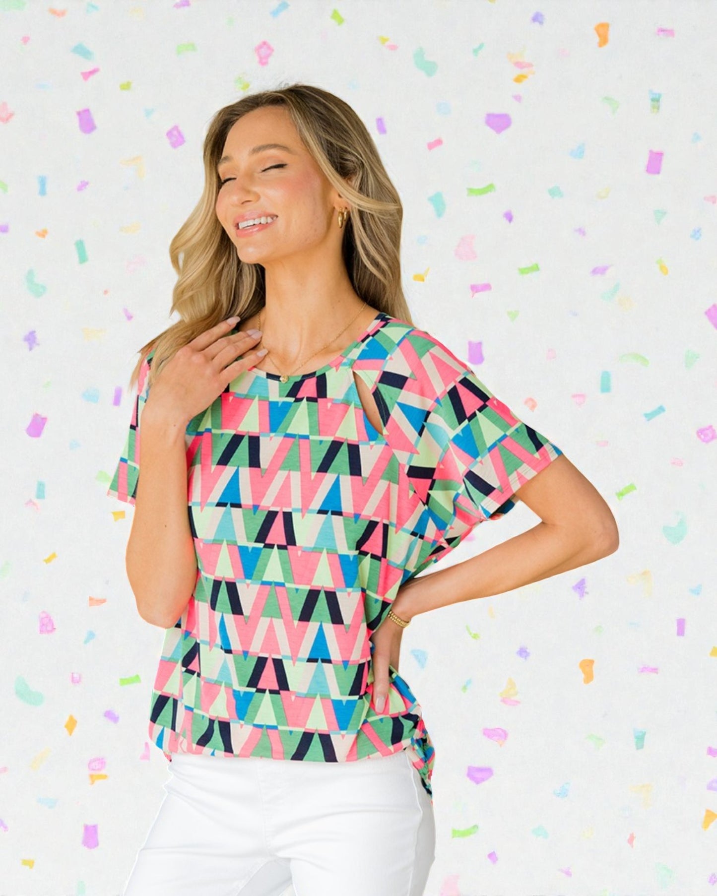 Woman wearing a colorful geometric patterned top against a multicolored confetti background
