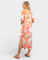 Woman wearing a colorful floral dress on a white background