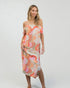 Woman wearing a colorful patterned dress on a white background