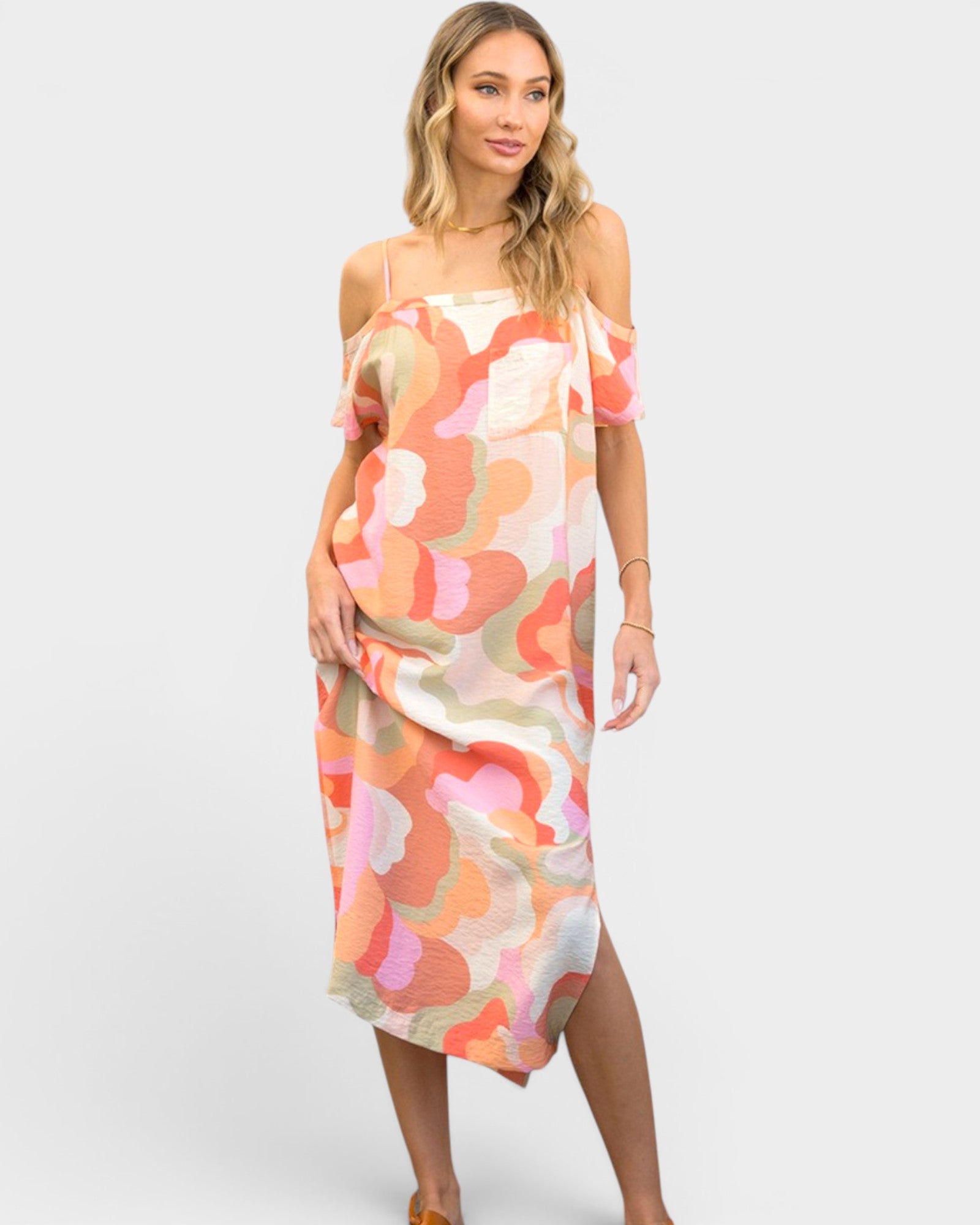 Woman wearing a colorful floral dress on a white background