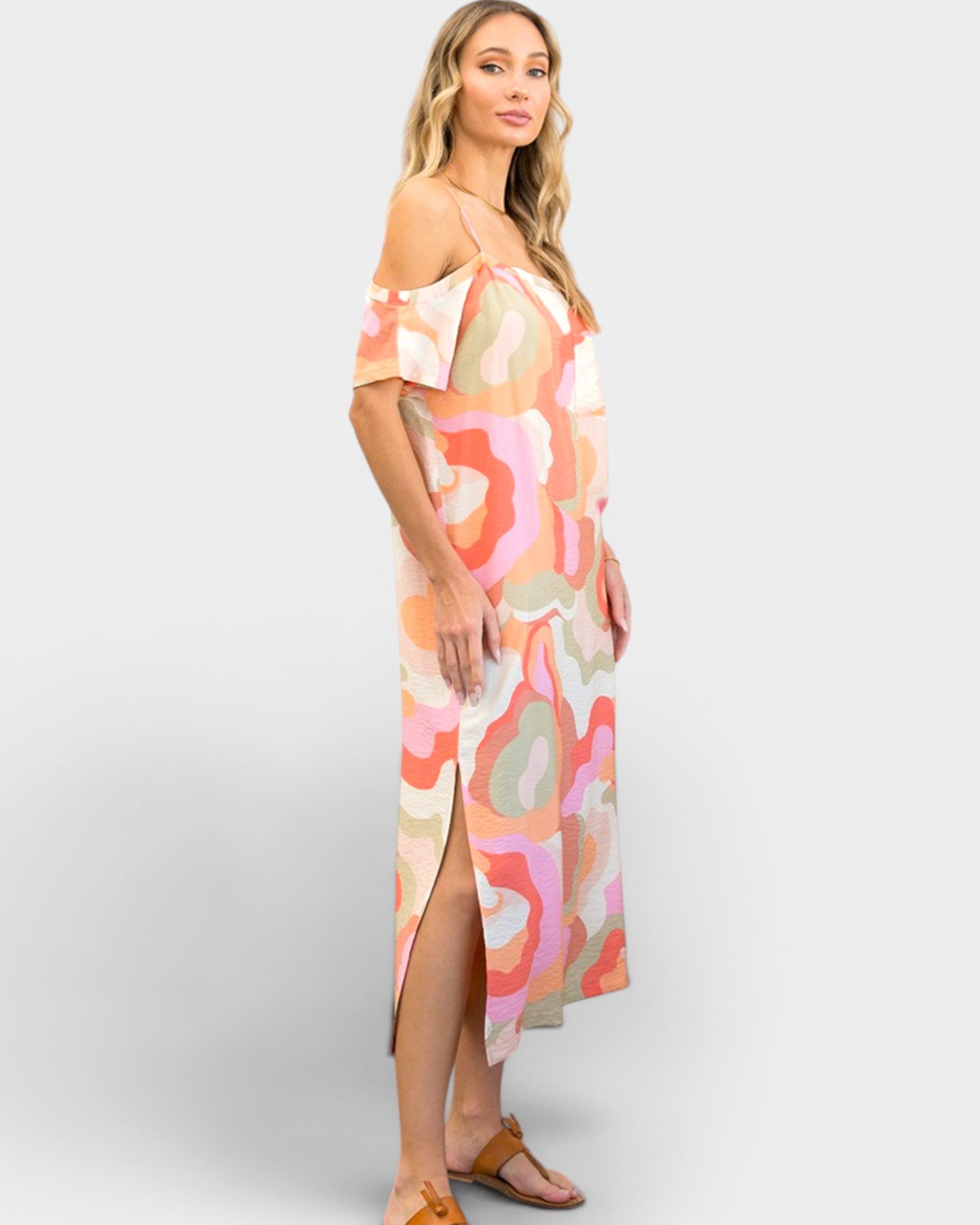 Woman wearing a colorful patterned dress on a white background