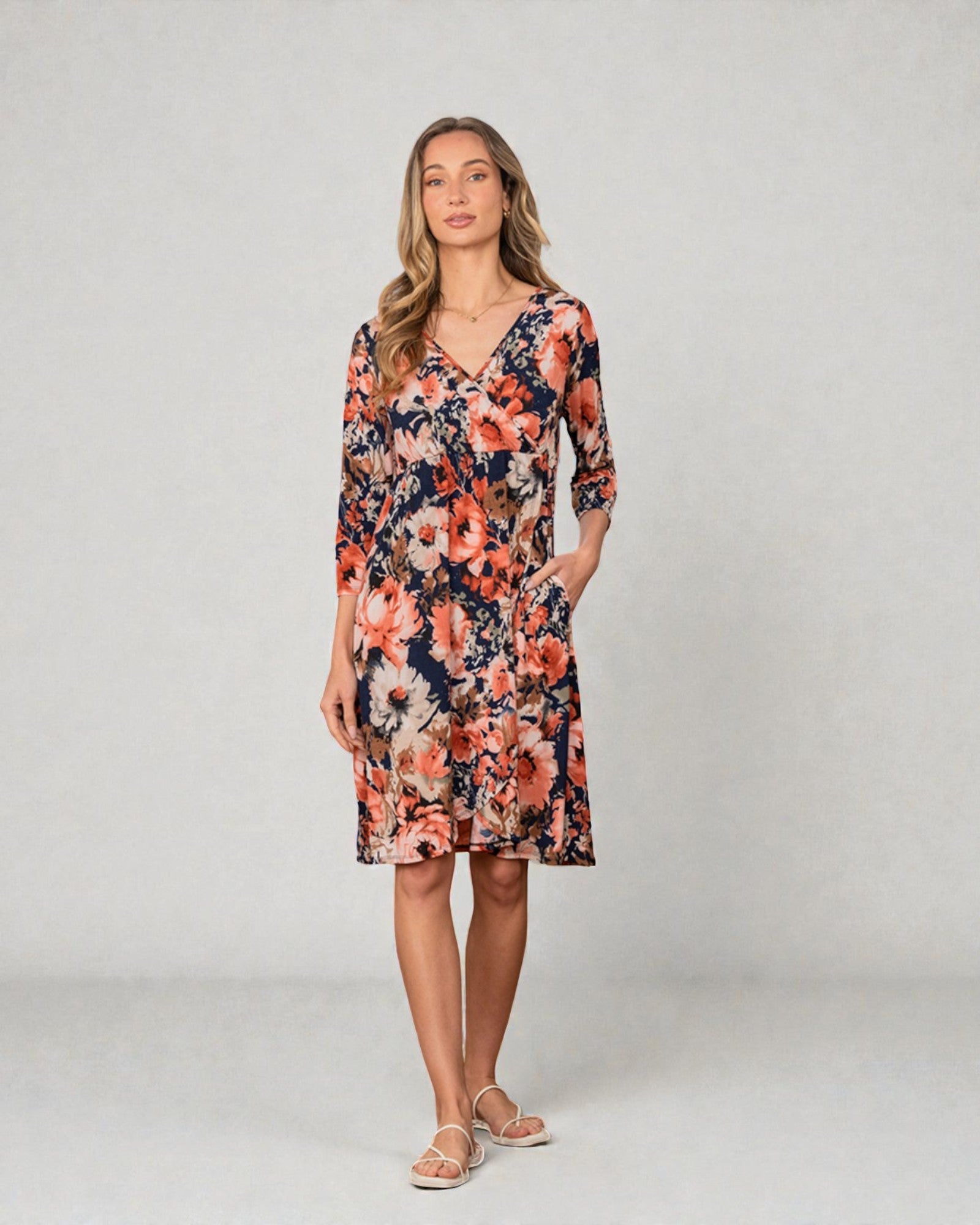 Woman wearing a floral dress on a plain background