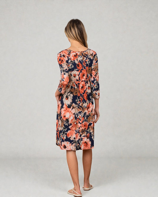 Woman wearing a floral dress on a plain background