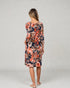 Woman wearing a floral dress on a plain background