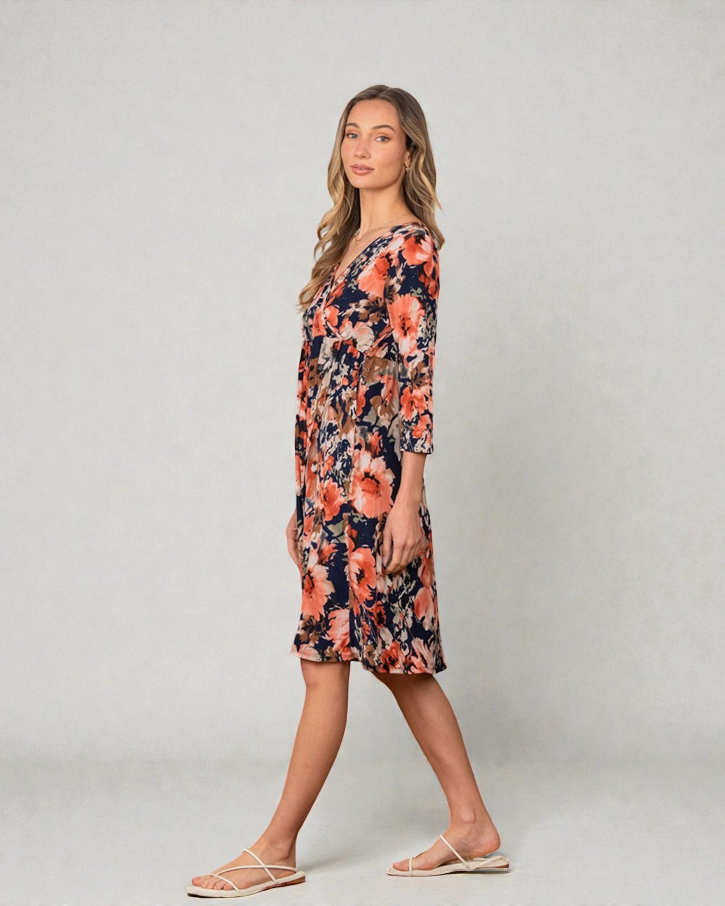 Woman wearing a floral dress on a plain background