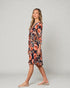 Woman wearing a floral dress on a plain background