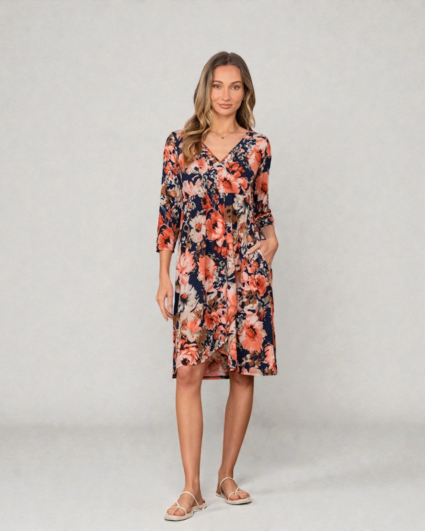 Woman wearing a floral dress on a plain background