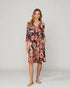 Woman wearing a floral dress on a plain background