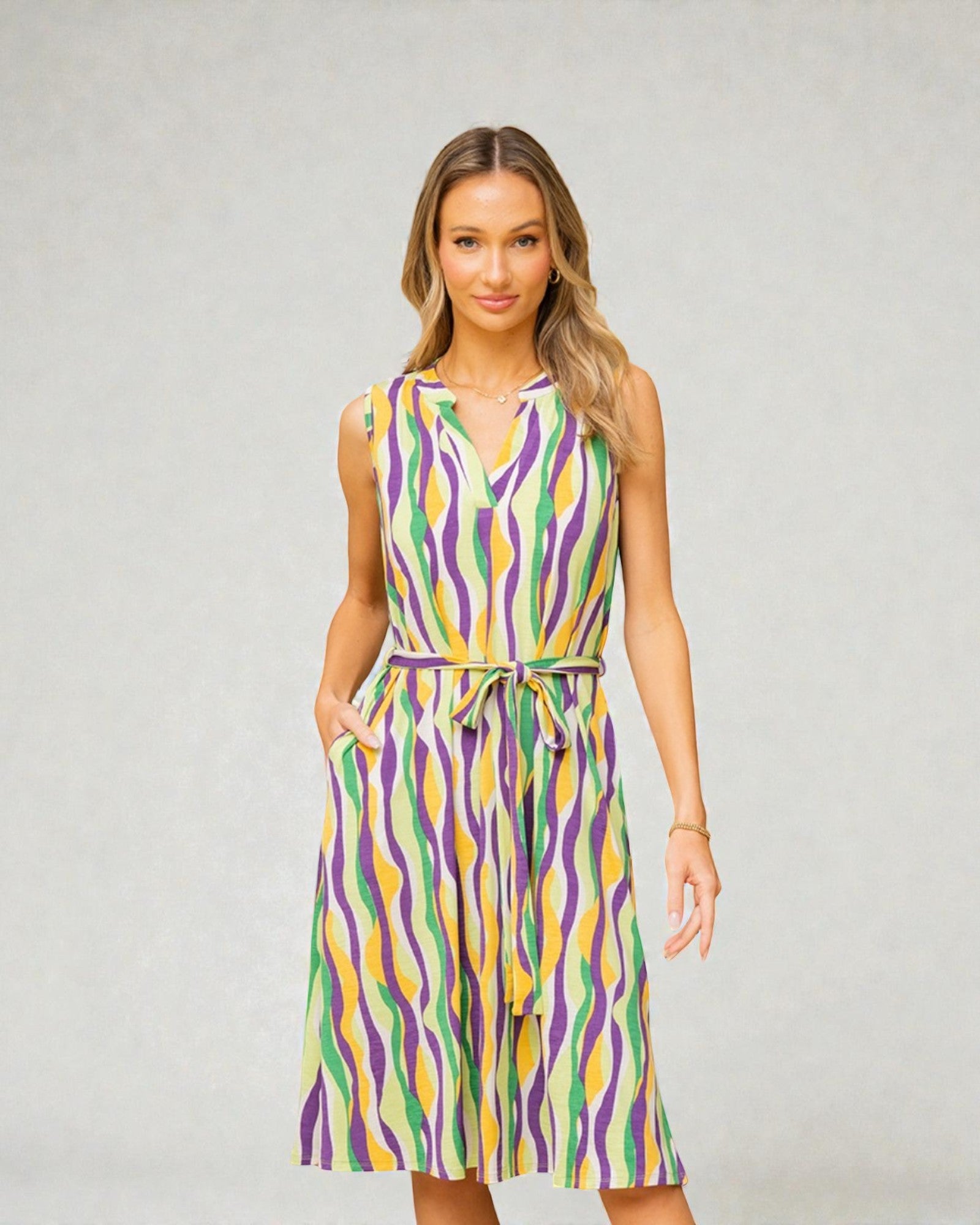 Woman wearing a colorful patterned dress against a plain background