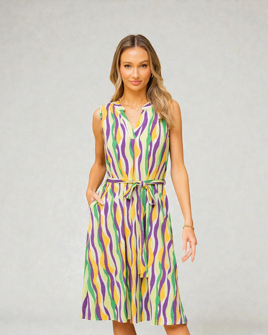 Woman wearing a colorful patterned dress against a plain background