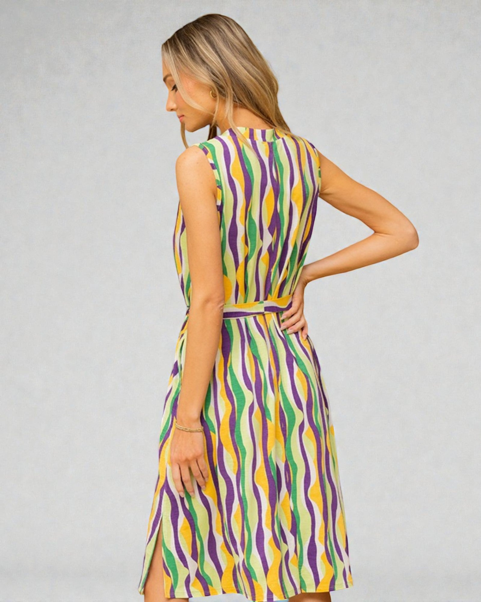 Woman wearing a colorful dress with a gray background