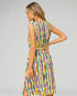 Woman wearing a colorful dress with a gray background