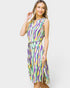 A woman modeling a sleeveless midi dress with a colorful wavy stripe pattern in purple, green, yellow, and white, featuring a tie waist belt, set against a plain light gray background.