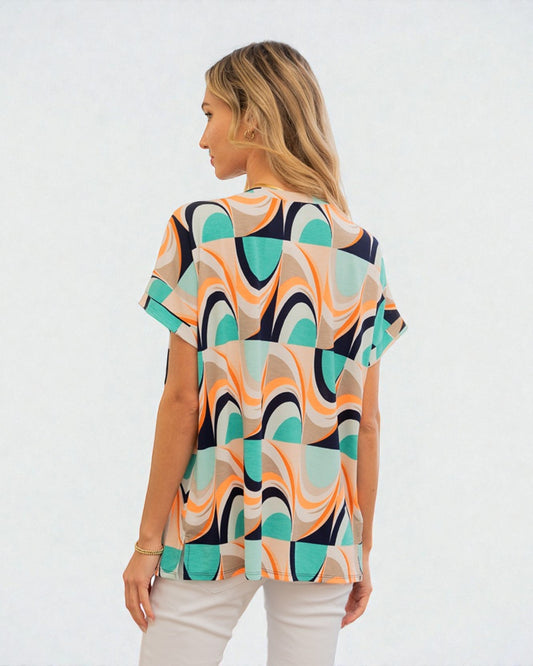 Woman wearing a colorful patterned shirt on a white background