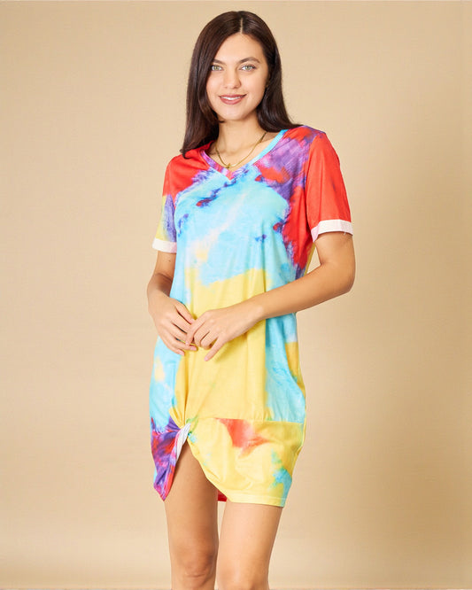 Woman wearing a colorful tie-dye dress on a beige background