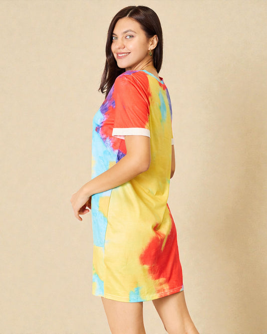 Woman wearing a colorful tie-dye dress on a beige background
