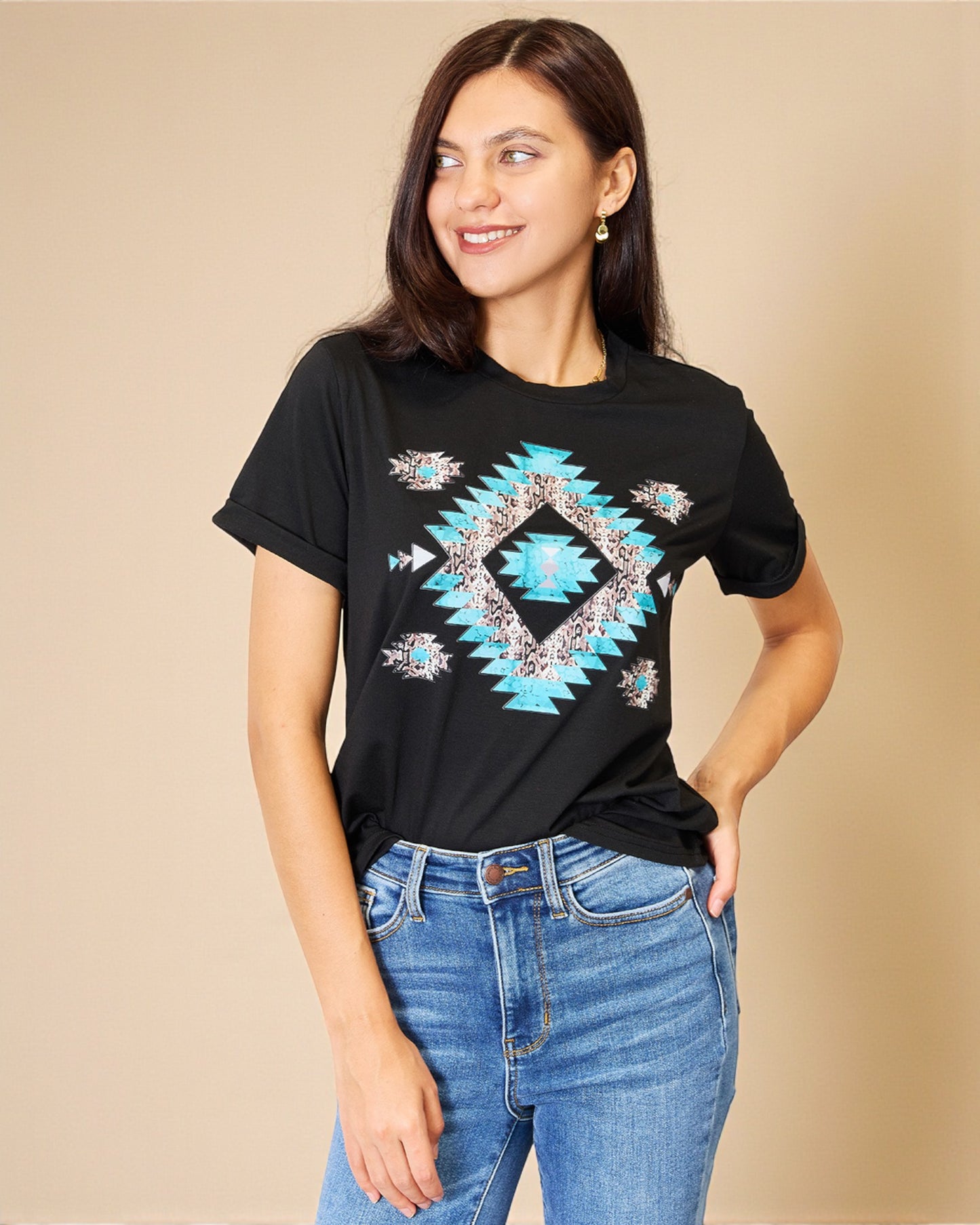 Woman wearing a black t-shirt with a blue geometric pattern on a beige background