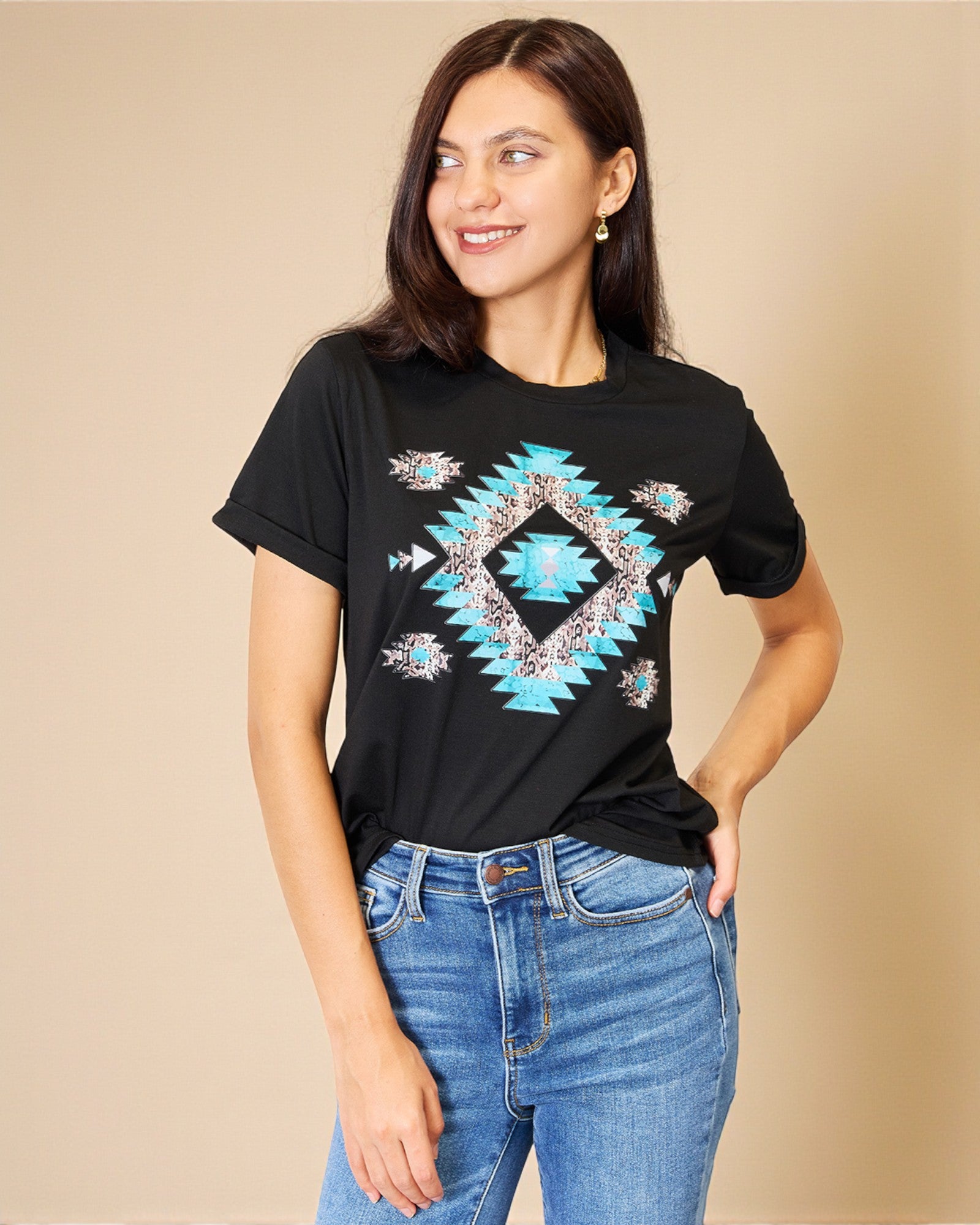 Woman wearing a black t-shirt with a blue geometric pattern on a beige background