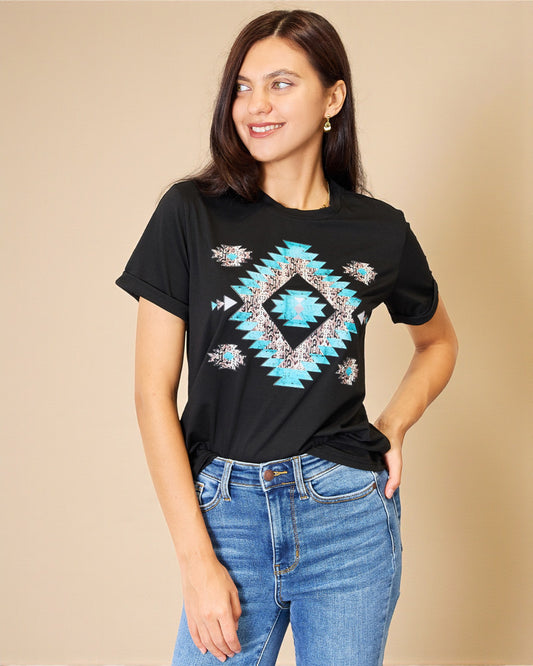 Woman wearing a black t-shirt with a blue geometric pattern on a beige background