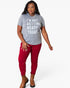 A woman modeling a heather gray graphic T-shirt with bold white text that reads 'I'M NOT GETTING READY TODAY.' paired with dark red pants and brown ankle boots, against a plain light gray studio background.